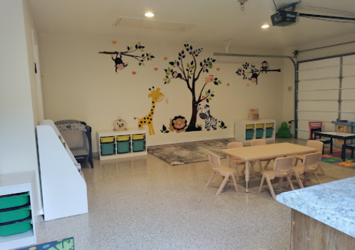 Indoor play area with hand-painted animal wall murals and organized activity stations
